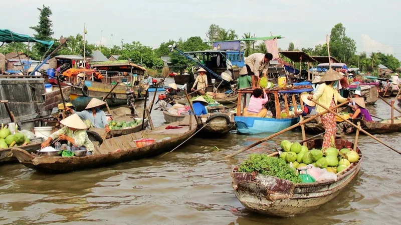 Wooden boats loaded with fruit and vegetables at a Mekong Delta floating market on a 3-day Vietnam tour package from Ho Chi Minh City, Vietnam