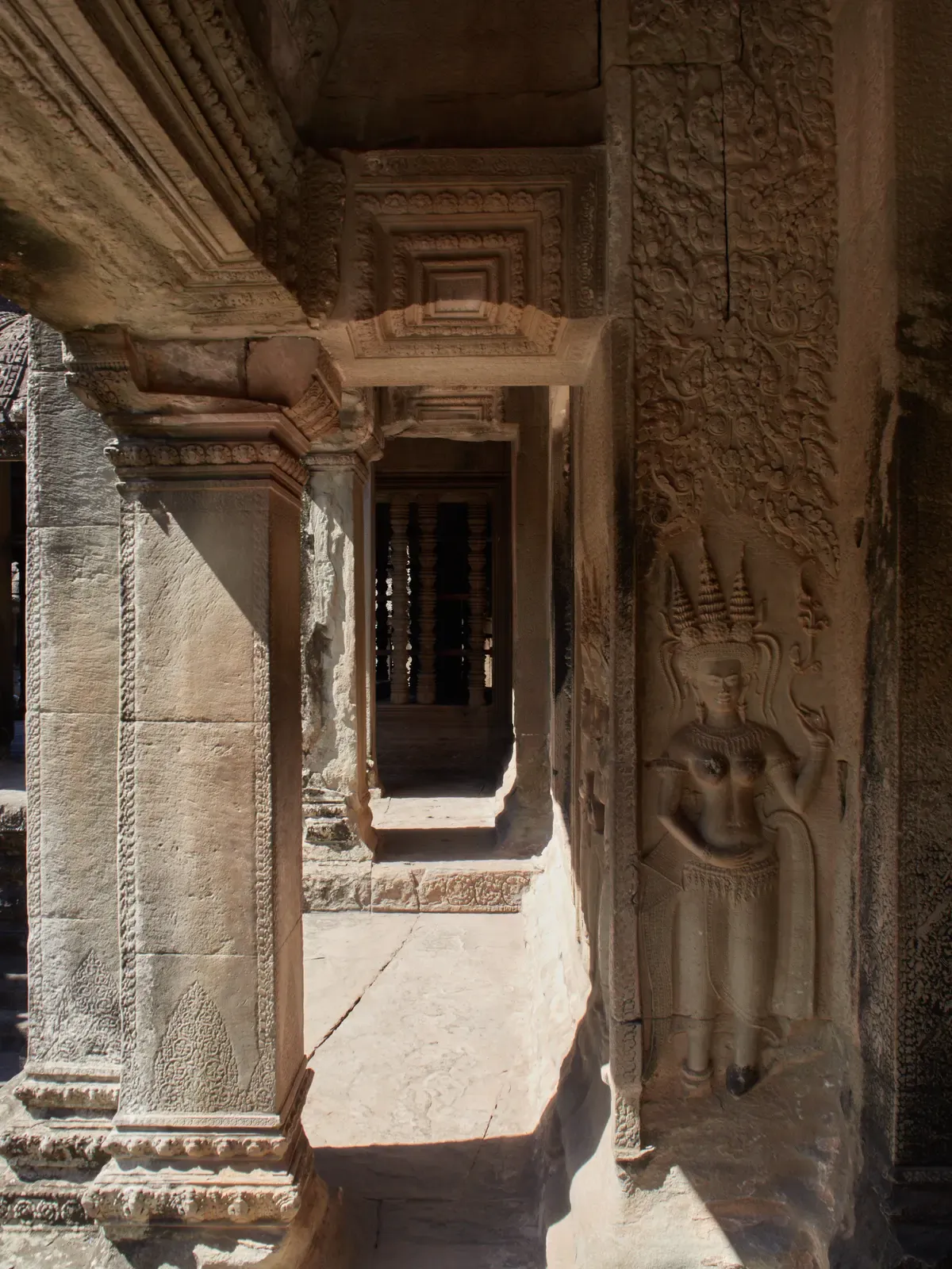 A carved apsara relief in a gallery at Angkor Wat on a 12-Day Vietnam and Cambodia Tour