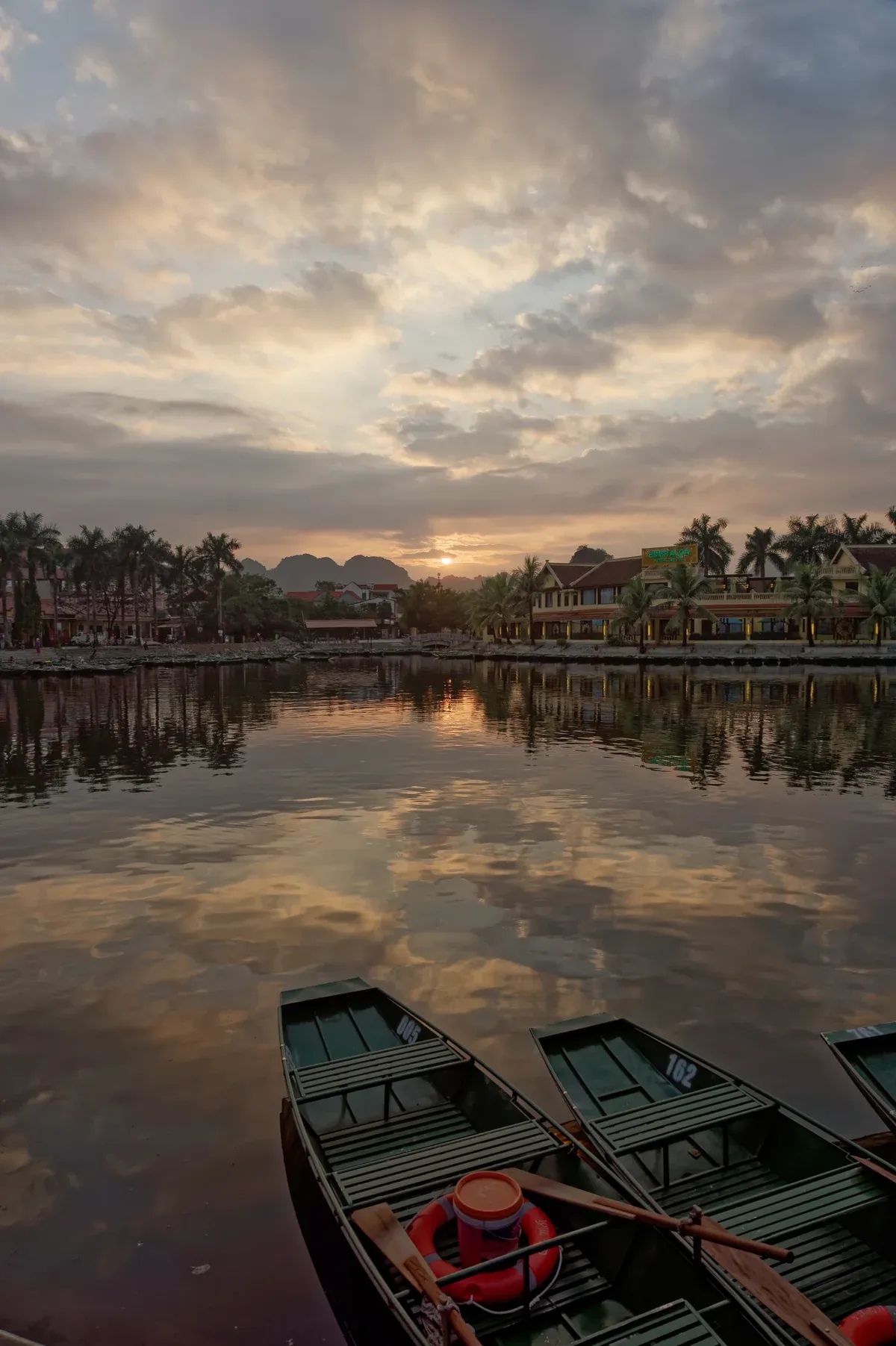 Boats at sunset in Ninh Hai, the Tam Coc area of Ninh Binh on a 2-Day Ninh Binh and Ha Long Bay Tour